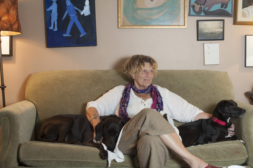 abigail thomas with two dogs on couch